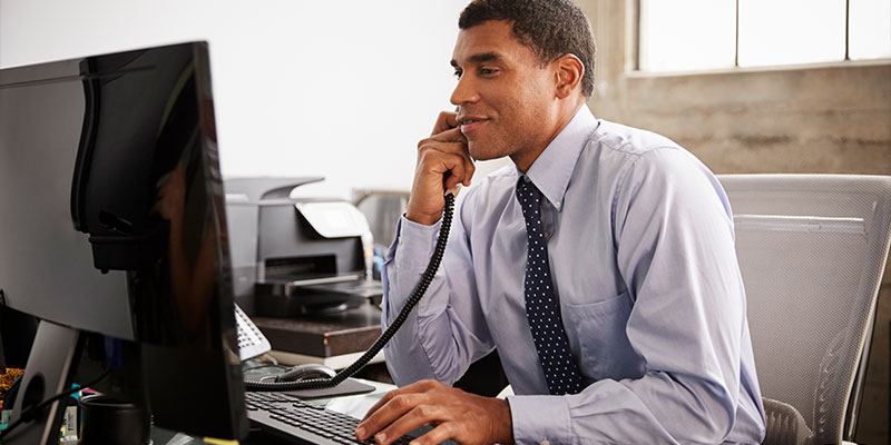 Attorney on the phone looking at a computer screen