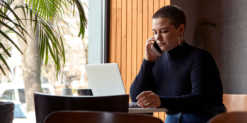 person on phone and computer