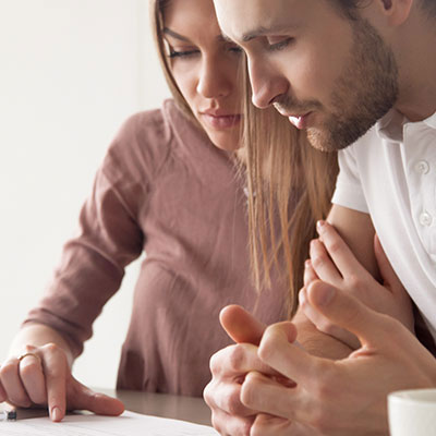 two people looking at paper documents