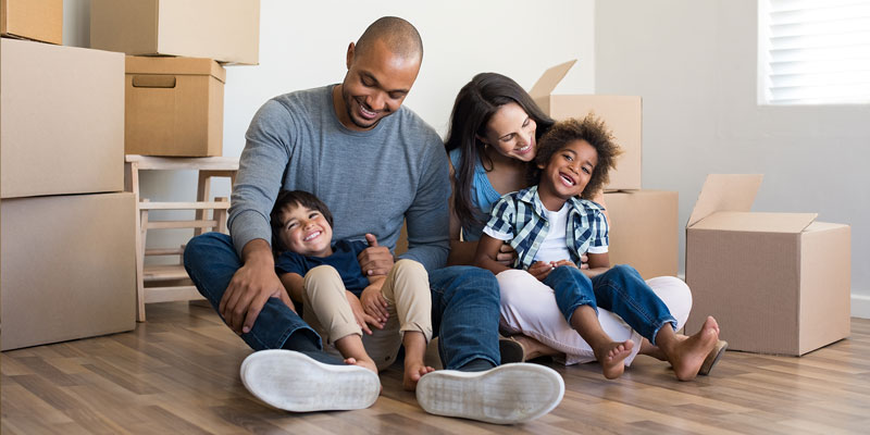 Family opening moving boxes